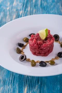 Single portion of beef tartar steak with capers Stock Photos
