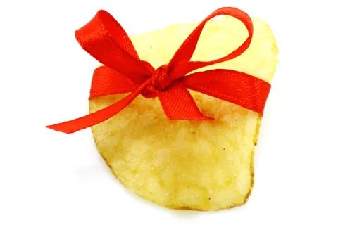 Single potato chip with red bow Stock Photos