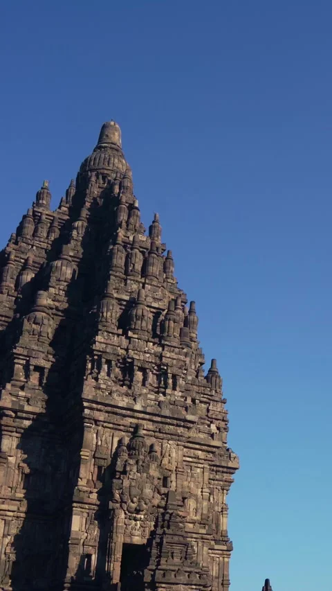 Single Prambanan Temple spire rises dramatically in a vertical low-angle vi.. Stock Footage 341545583