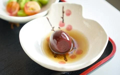 Single preserved Quail eggs egg served in small white bowl Stock Photos