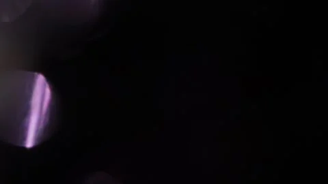Single purple crystal light on the left in the blackness Видео 318367401