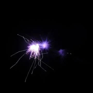 Single purple firework on black background Stock Photos