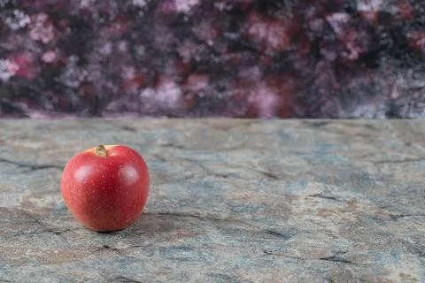 A single red apple on a marble background Stock Photos