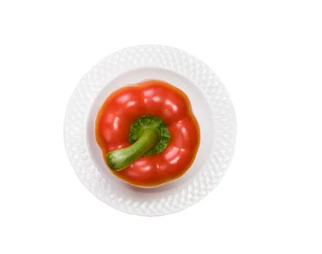 Single red bell pepper on white plate isolated on white background Stock Photos