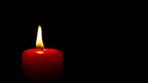 Single red candle flame lights, isolated on a black background Stock Footage 239810482