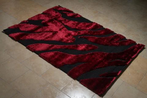 Single red carpet folded on floor Stock Photos
