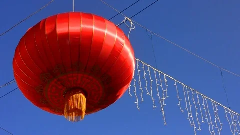 Single red chinese lantern in the blue sky Stock Footage 103316301
