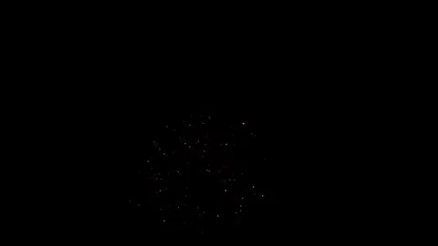 Single red firework burst exploding against black night sky Video stock 329673813