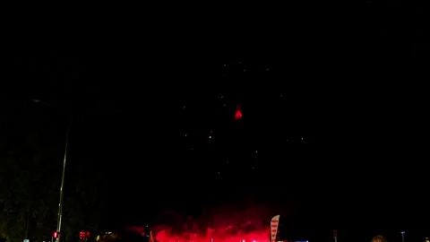 Single red firework exploding over crowd during nighttime festival in Annecy Stock Footage 321943247