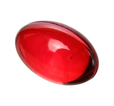 A single red gel capsule or vitamin in close-up against an isolated backgroun Stock Photos