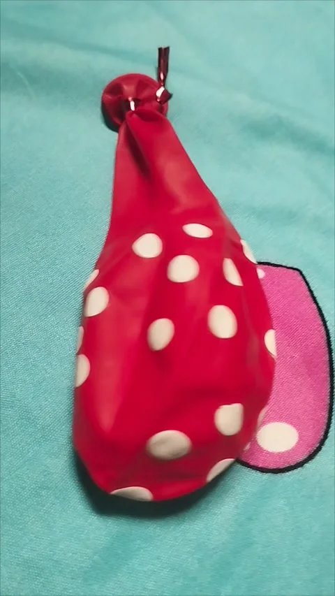 Single Red Polka Dot Balloon on Blue Background Stock Footage 296035836