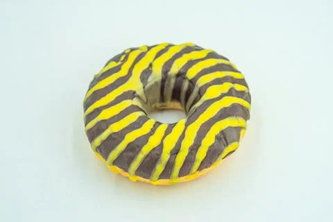 A single, ring-style doughnut with a distinctive zebra print icing pattern is Stock Photos