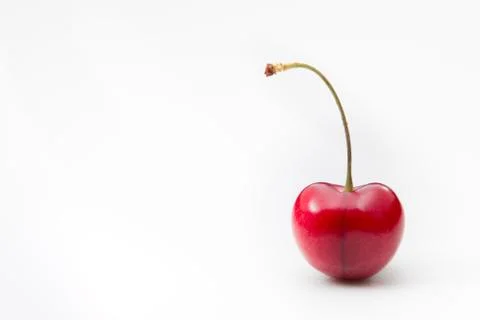 Single ripe cherry on a white background. Stock Photos