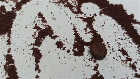 A single roasted coffee bean surrounded by coffee grounds on a white background Video stock 323579641