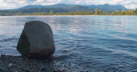 Single Rock with Small River Waves 4K Stock Footage 160146771