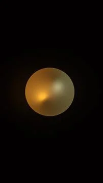 A single, round light fixture hangs in a dark room Stock Photos