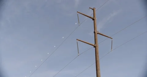 Single Rusted Pole with Power Lines Against Blue Sky Stock Footage 89942575