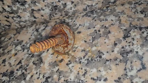 A single, rusted screw with a damaged head and stripped Vídeo Stock 315310814