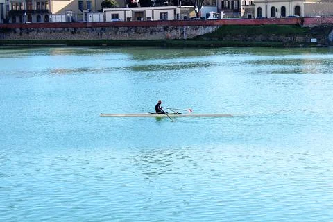 Single Sculler Rowing on the Arno River in Florence, Tuscany, Italy Stock Photos