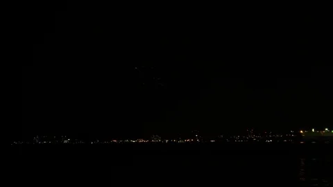 Single shot of fireworks with reflections on the sea, 4K Stock Footage 113377361