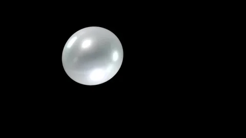 Single Silver Balloon Falling Gracefully on the Left Against a Deep Black Stock Footage 303633037
