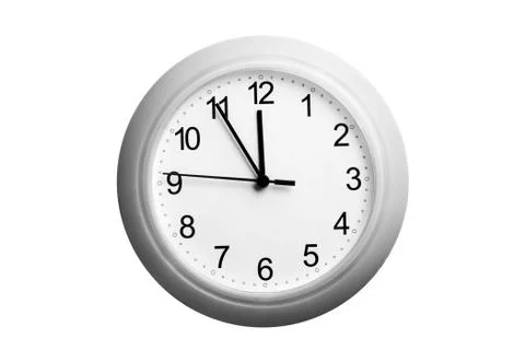 A single simple clock showing the time five to twelve Stock Photos