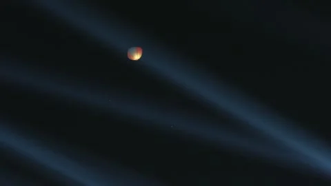 Single sky lantern drifting high in dark night sky over Porto Video stock 345852862