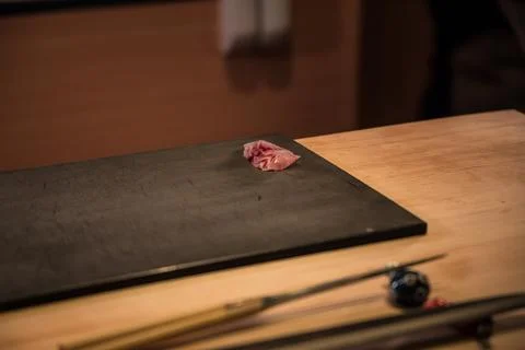 Single slice of sashimi on dark board Stock Photos