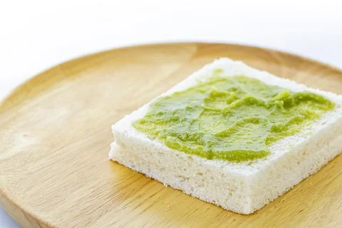 A single slice of white bread with a spread of Pandan Custard is placed on .. Stock Photos