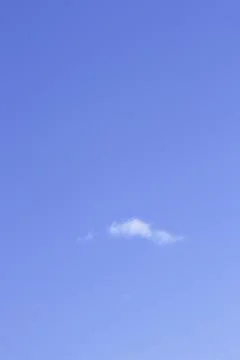Single small cloud over blue sky Stock Photos