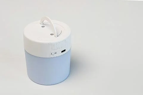 A single small portable electric lantern light standing vertically on a pla.. Stock Photos