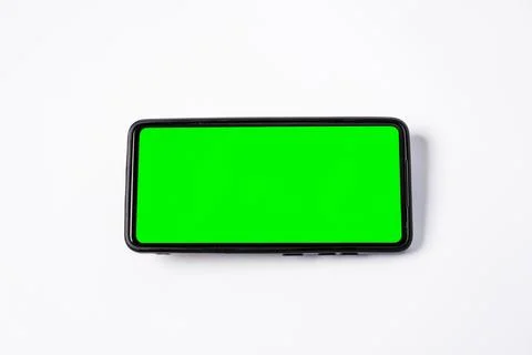 A single smartphone key green screen placed horizontally at the center of a.. Stock Photos
