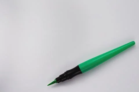 Single smooth green marker brush on white background with copy space Stock Photos