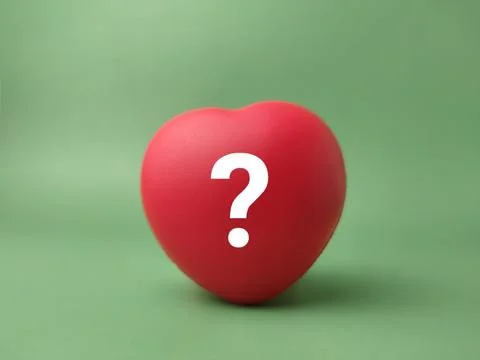 A single smooth red stress ball shaped like a heart features an overlaid wh.. 库存照片