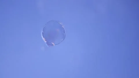 Single soap bubble slowly floating downwards Stock Footage 343495073