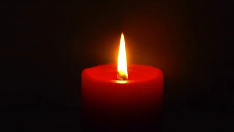 Single soft red purple candle light black background Stock Footage 79335804