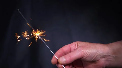 Single sparkler firework against dark background Stock Footage 171238621