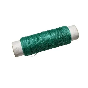 Single spool of emerald green sewing thread on white background 스톡 사진