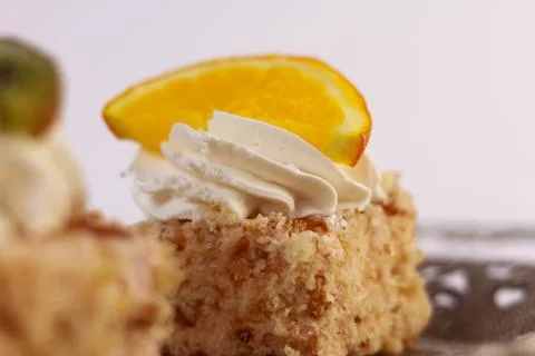 Single square piece of vanilla sponge cake layered with whipped cream Stock Photos