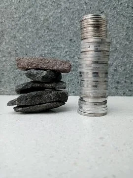 Single Stack of Coins Taller Than a Pile of Crushed Stones Stock Photos