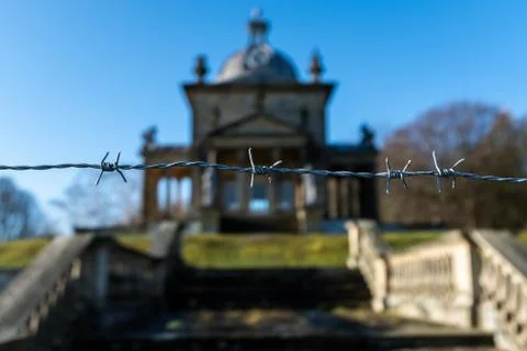 A single strand of barbed wire outside an historic building Stock Photos