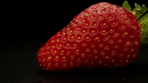 Single Strawberry On Black Background Camera Paning to the right Stock Footage 131800382