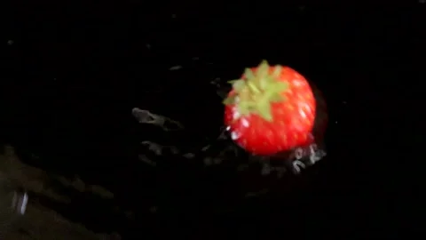 Single Strawberry Falling Into Water With A Black Dark Backdrop Stock-Footage 136432848