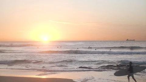 Single surfer runs with board on beach Stock Footage 107050443