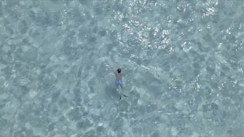 Single swimmer with a starfish Drone in the Caribbean Stock Footage