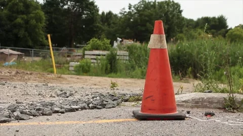 Single tall beat up marked pylon with black bottom and thick white stripe at top Stock Footage 246611724