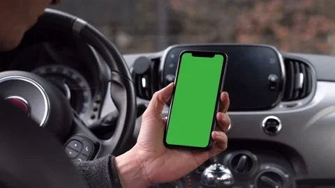 Single Tapping and Holding a Green Screen Smartphone in a Car Stock Footage 145150796