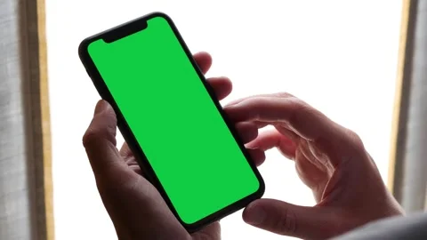 Single Tapping and Holding a Green Screen Smartphone at Home Stock Footage 249053963