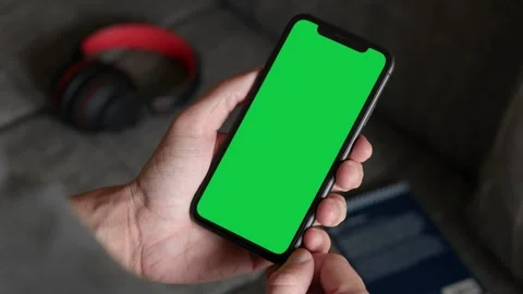 Single Tapping and Holding a Green Screen Smartphone at Home Stock Footage 251164240