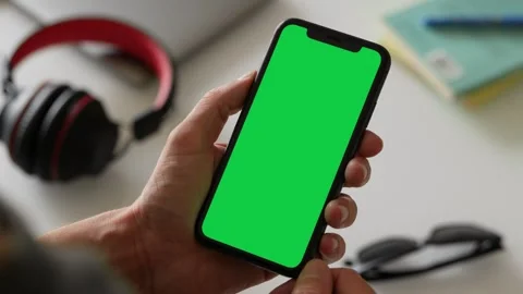 Single Tapping and Holding a Green Screen Smartphone at Home Stock Footage 251164241